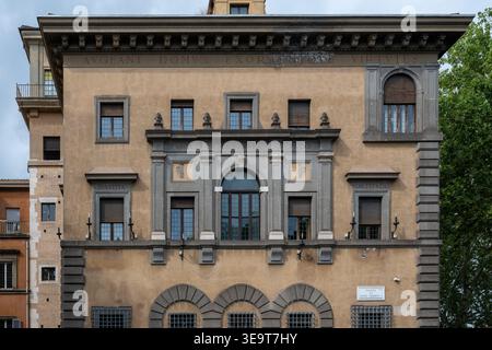 Rome, Italy - Aug 29, 2025: Street-level view of Teatro Tordinona building facade in Rome, with arched windows, grey stone framing, and barred ground- Stock Photo