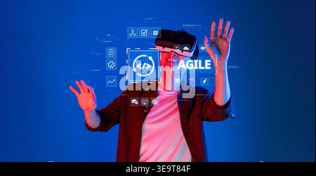 A person engages with virtual reality technology, demonstrating agile principles in a captivating digital environment, highlighting innovation and Stock Photo