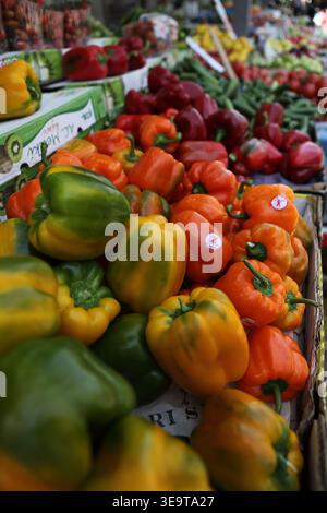 Peppers, Green, yellow, orange & red, various vegetables for sale, seen on a market stand in the open Ramla city fresh produce market. Stock Photo
