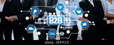 A diverse business team collaborates on effective B2B strategies, using modern technology and digital icons to enhance sales and agreements in a Stock Photo