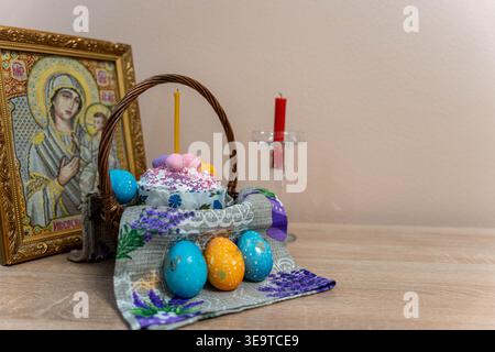 Easter Eggs In Decorative Cloth, Intimate Home Altar Setup With Framed Icon And Lit Candle, Painted Eggs Nestled On Embroidered Towel And Wicker Stock Photo