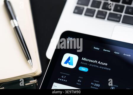 Microsoft Azure listing on iPad highlights Apple Liquid Glass updated design and iOS 26 look in office desk scene. Stafford, United Kingdom, April 13, Stock Photo