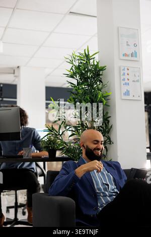 Businessman smiling during video call with customer using digital table, discussing product launch on market. Startup arab founder having online chat with business partner Stock Photo