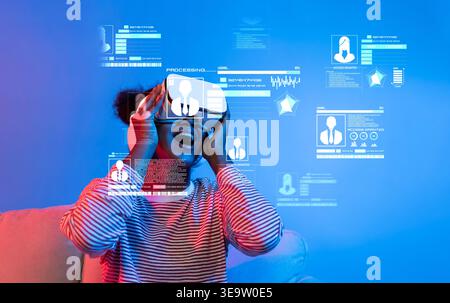 A young user immersed in a virtual reality experience, showcasing the dynamic realm of digital identity and cybersecurity through interactive graphics Stock Photo