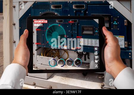 Engineer use augmented reality software in smart factory production line with automated application . Futuristic machinery in working in concept of Stock Photo