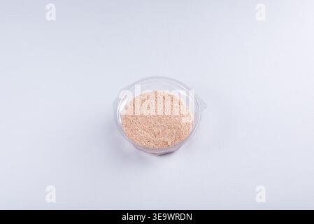 Studio shot showcases protein powder in transparent container, isolated minimal on white. Even lighting emphasizing textures. Ideal for nutrition, fit Stock Photo