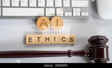 Top view of AI ethics wooden blocks and legal gavel placed next to computer keyboard for technology regulation concept Stock Photo