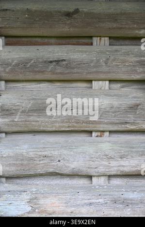 Old-fashioned rustic building exterior built weathered and sun bleached half logs Stock Photo