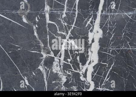 Marble stone with white veins on dark surface Stock Photo