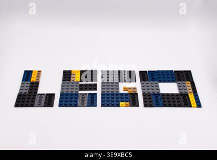 The word Lego spelled out with colorful plastic building blocks on a clean white background. Stock Photo