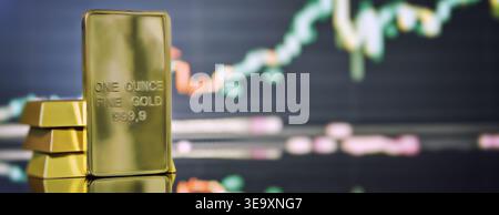 Macro shot of a 999.9 pure gold bullion bar standing on a reflective surface with a glowing financial candlestick chart in the blurred background. Con Stock Photo
