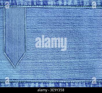 Blue denim texture with a seam and jeans label. Light blue color denim jeans material and vintage tag. Denim fabric is a light blue shade, with a vint Stock Photo