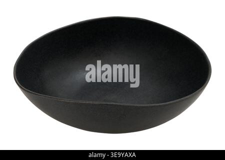 Empty black bowl made of ceramic on white background. Modern kitchenware for dinner service. Minimalist table setting for home interior and restaurant Stock Photo