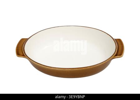 Ceramic baking dish with handle isolated on white background. Empty round casserole vessel for kitchen oven cooking. Rustic pottery bakeware for food Stock Photo