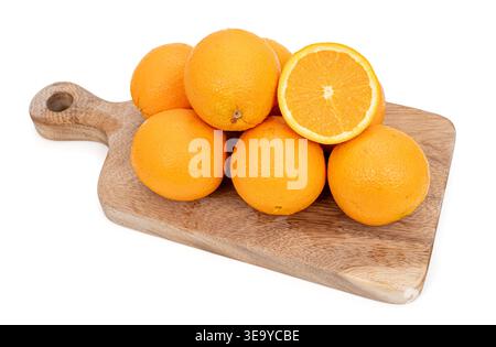 Group of fresh oranges with water drops on a wooden tray isolated on white background. Stock Photo