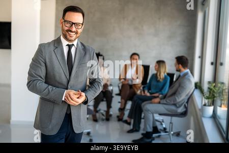 Multicultural professional businesspeople working together on research plan in boardroom. Stock Photo