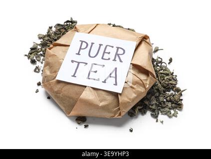 Dry pressed puer tea wrapped in paper and sticky note on white background Stock Photo
