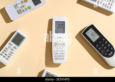 Air conditioner remote controls on beige background Stock Photo