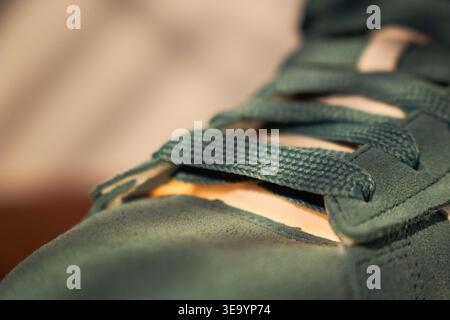 Comfortable suede shoe with refined stitching and grain. Detailed description of suede toe box with textured laces and wear marks Stock Photo