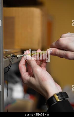 male hands using a small screwdriver Stock Photo