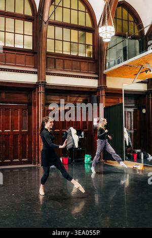 Young ballerinas practicing ballet steps in spacious studio Stock Photo