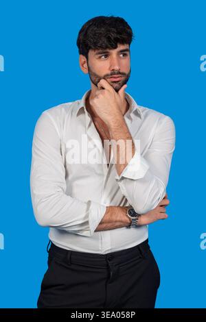 Man with beard and white shirt contemplating, finding solutions Stock Photo