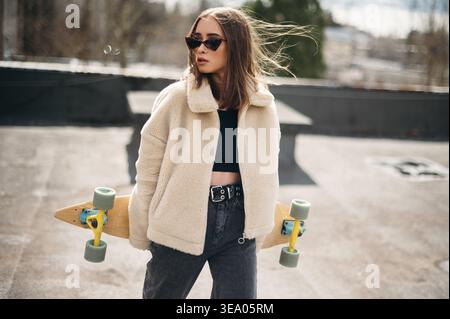 Stylish Woman with Skateboard on Sunny Day Stock Photo