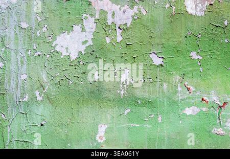 Texture of old concrete wall with cracks and green peeling paint. Cracked grunge wall background Stock Photo