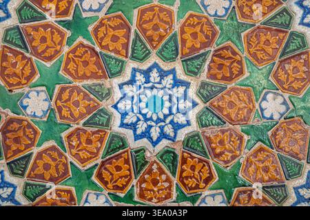 Closeup detail view of ancient colorful ceramic tiles floral motif on wall of Makhdum Nuh tomb, Hala, Sindh, Pakistan Stock Photo