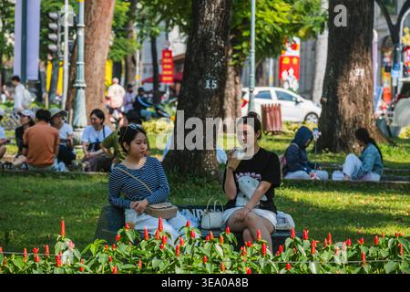 Friends Relaxing on a Bench in a Public Park Stock Photo