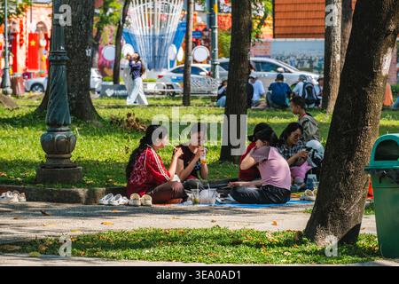 Friends Relaxing on a Bench in a Public Park Stock Photo