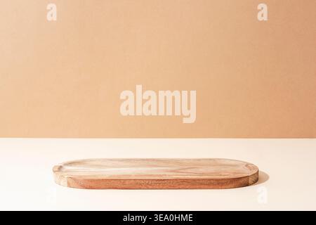 Wooden tray on beige background. Minimal natural composition, mockup. Front view Stock Photo