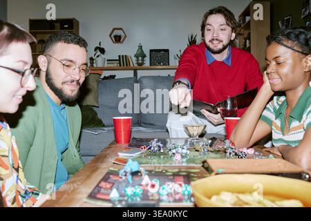 Diverse Adult Friends Playing Board Game during Social Gathering Stock Photo