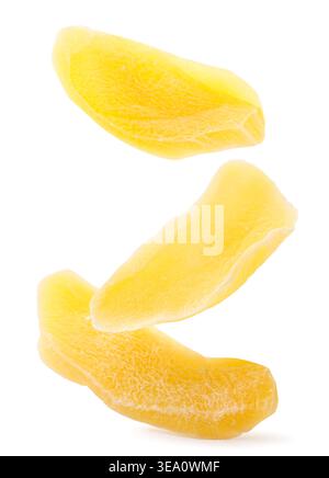 Dried mango slices falling close-up on a white background. Isolated Stock Photo