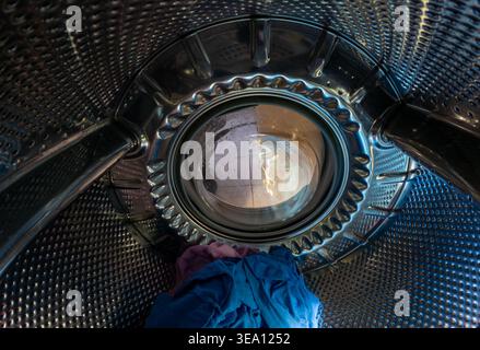 Inside View of Washing Machine Drum with Colorful Laundry Stock Photo