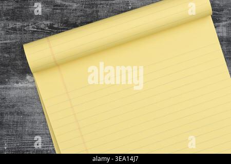 Yellow legal pad notebook on dark rustic wooden desk, showing lined paper ready for notes, planning, writing ideas, and productivity. Stock Photo