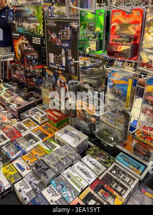 Colorful toy cars fill a vibrant display. Boxes and cases hold diverse collectibles. Shelves stacked with assorted vehicle models. Bright packaging ca Stock Photo
