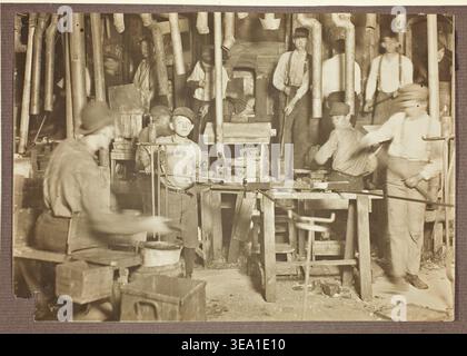 Untitled by Lewis Wickes Hine, c. 1908, interior of a woodworking shop with multiple male workers operating lathes and hand tools Stock Photo