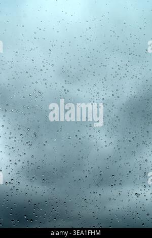 The weather is bad. Raindrops glisten on the windowpane against the backdrop of a gloomy, cold sky. It doesn't feel cozy. There's nothing cozier than Stock Photo
