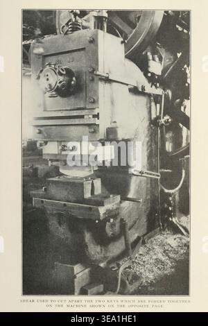 Heavy duty industrial shear machine actively cutting components, demonstrating the process of separating forged metal parts in a manufacturing environment. from the Article ORGANIZATION AND ECONOMY IN THE RAILWAY MACHINE SHOP. By H. W. Jacobs. Part 1. SPECIALIZING AND CENTRALIZING THE OPERATIONS AND EQUIPMENT. From The Engineering Magazine Devoted to Industrial Progress Volume XXXI April - September 1906 The Engineering Magazine Co Stock Photo