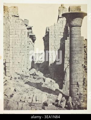 Palais de Karnak, Cour des Bubastites et Entrée Principale de la Salle Hypostyle; Thèbes by Maxime Du Camp, 1849–51, printed 1852. Monumental temple ruins with towering stone columns and massive walls framing a sandy courtyard in ancient Egypt Stock Photo