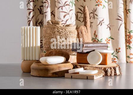 Natural Handmade Soap Bars Collection on Wooden Podiums with Rustic Bath Accessories and Eco Decor. Assortment of Soaps and Loofah still life Stock Photo