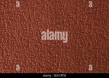 Tiny bumps create a tactile, gritty texture. Warm tones suggest aged metal or weathered material. Ideal for backgrounds or industrial design elements Stock Photo