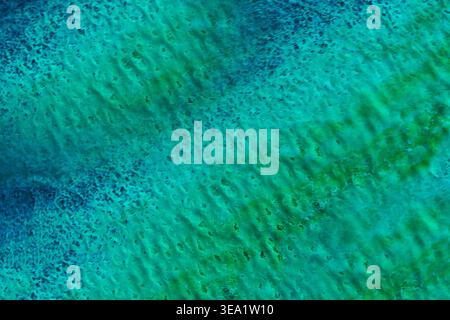 Deep blues swirl into greens, forming organic patterns. Textured water movement evokes calm, serene energy. Perfect for backgrounds Stock Photo
