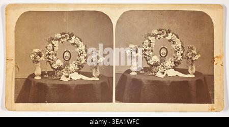 Untitled by Artist unknown, 1875–99, stereoscopic study of floral wreaths arranged on draped table with portrait medallions and ceramic vessels Stock Photo
