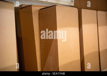 cardboard boxes stacked in warehouse storage, shipping packaging containers. Concept: e-commerce logistics Stock Photo