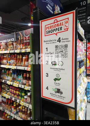 The image features a vertical, close-up shot of a white informational sign for a "PERSONAL SHOPPER" service, prominently displayed on the side of a re Stock Photo