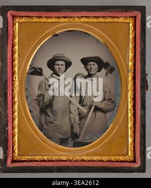 Untitled (Portrait of Two Men Holding Shovels) by Unknown maker, 1868, two male laborers in work shirts and wide-brimmed hats posing with hand tools Stock Photo