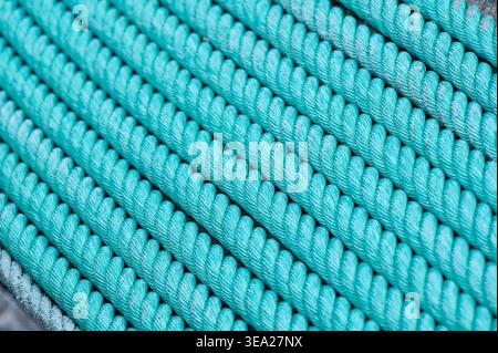 Twisted ropes forming a strong, repetitive pattern with vibrant turquoise color. Closeup showing lines and detailed texture Stock Photo