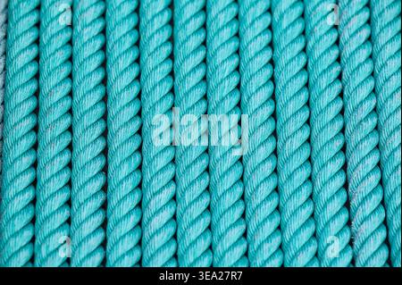 Aqua rope tightly winding into a seamless pattern, providing a textured surface for nautical, abstract, and industrial designs Stock Photo